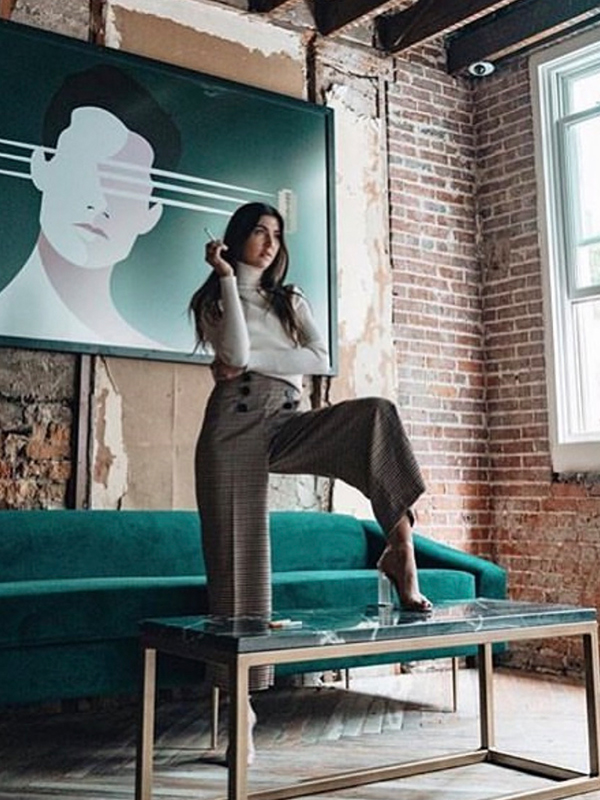 model possing with green sofa and painting at the back doral fl